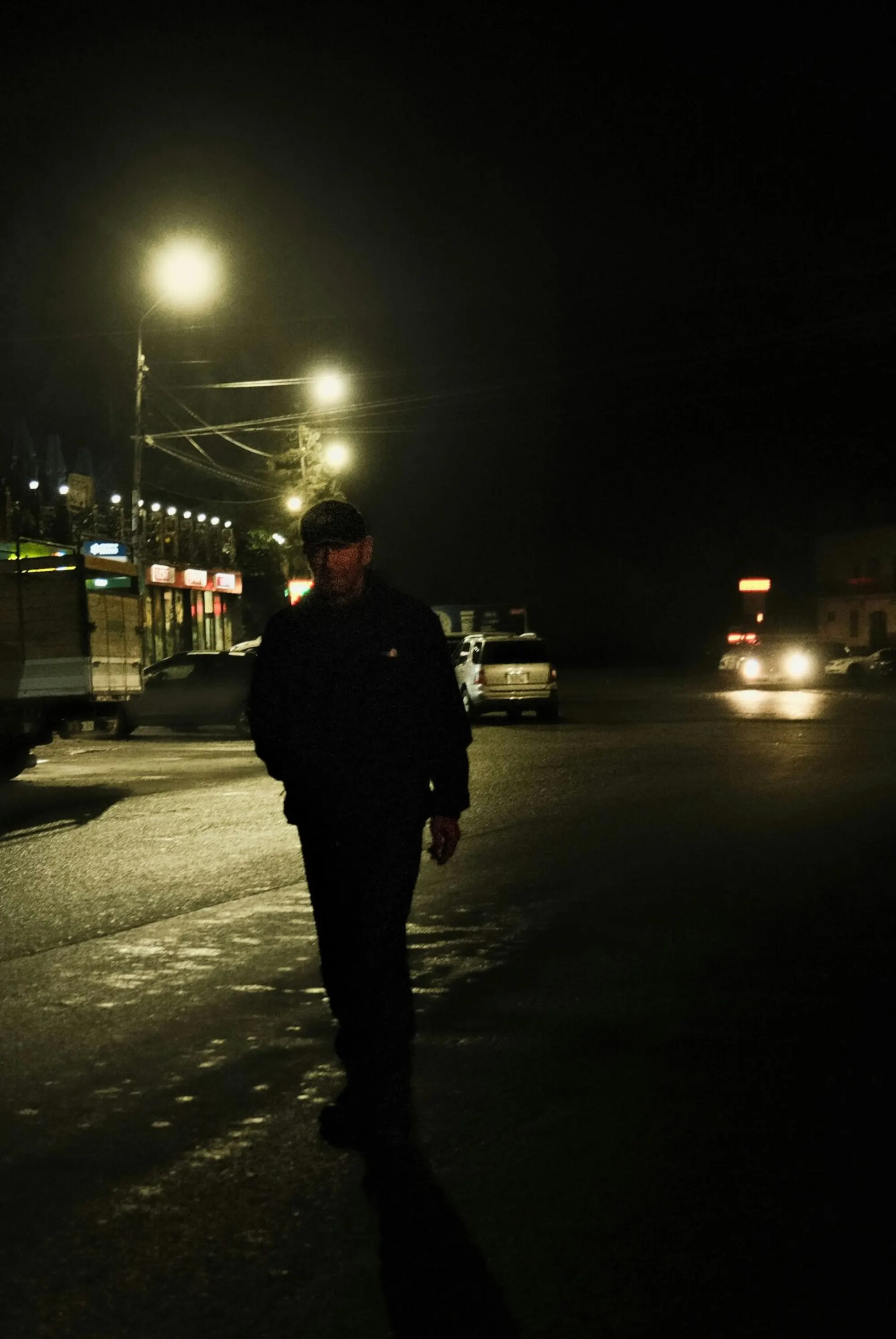 Headlights on a wet street at night