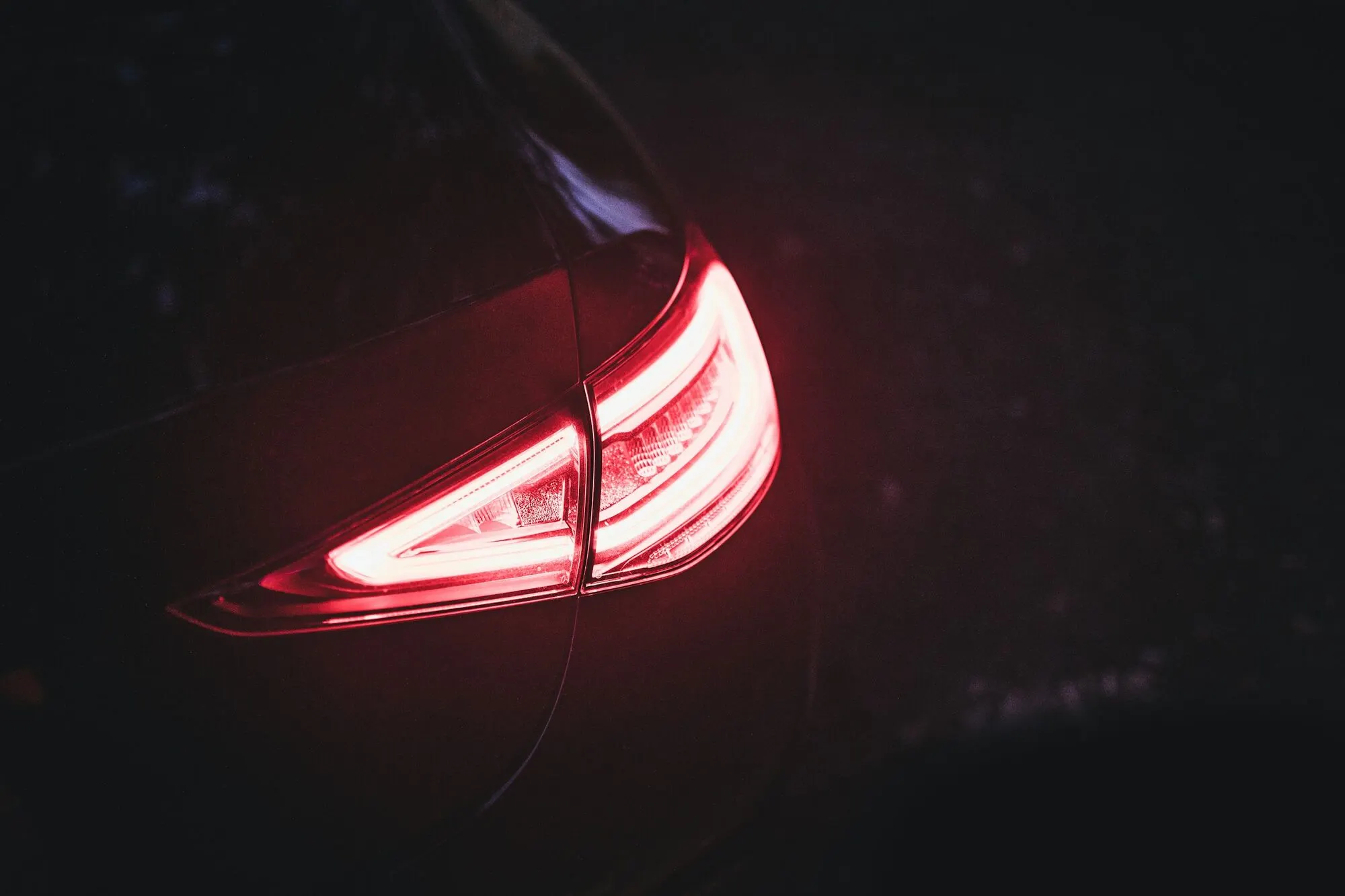 Convoy of vehicles in motion, rear lights