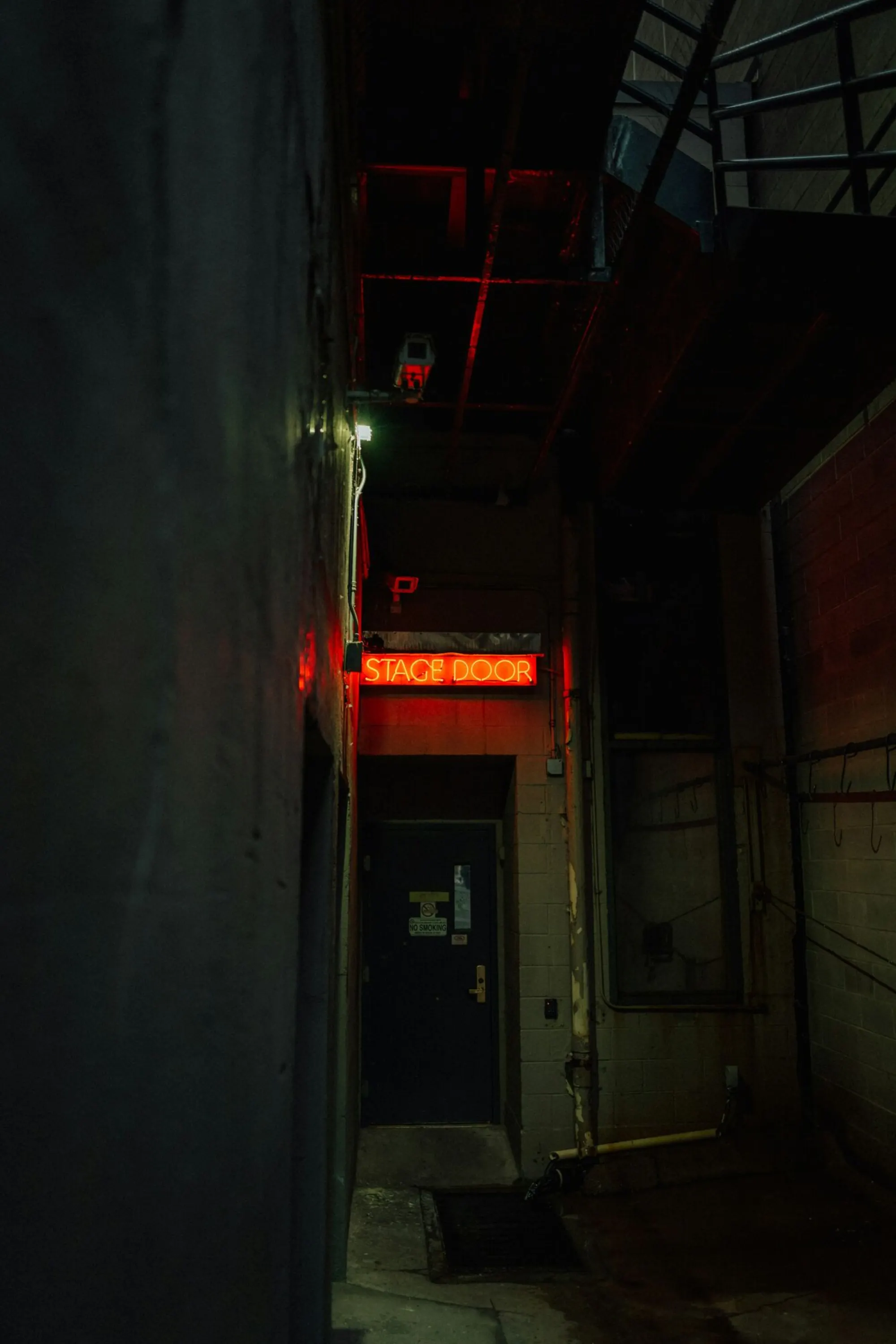 Event floor operator in a backstage venue corridor, side cabling visible